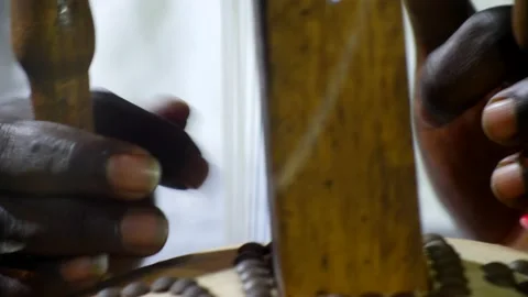 Black hands plucking the strings of kora instrument from front Stock Footage 208940709