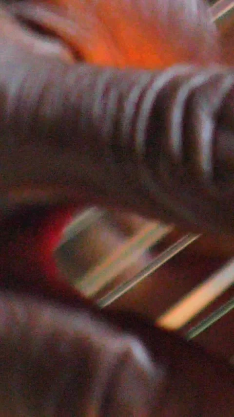 Black hands plucking the strings of kora instrument from side Stock Footage 230692011