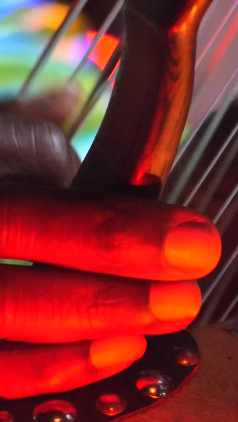 Black hands plucking the strings of kora instrument from side Stock Footage 230692024