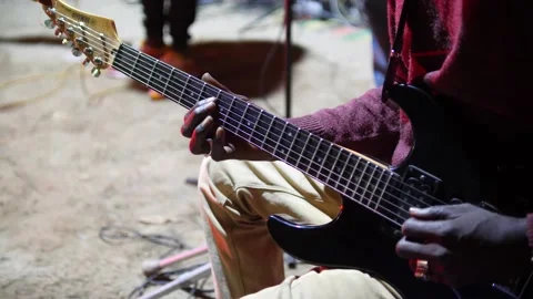 Black hands with ring playing with plectrum on electric guitar up side down 스톡 동영상 208939956