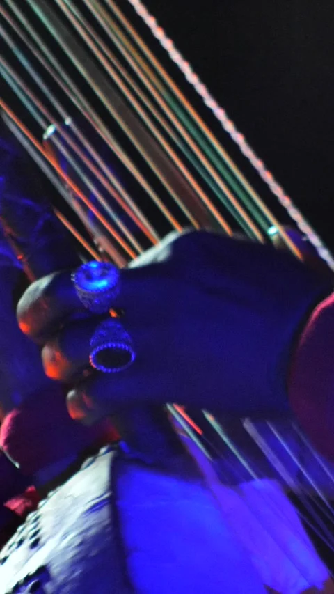 Black hands with rings plucking strings of kora instrument Stock Footage 230691674