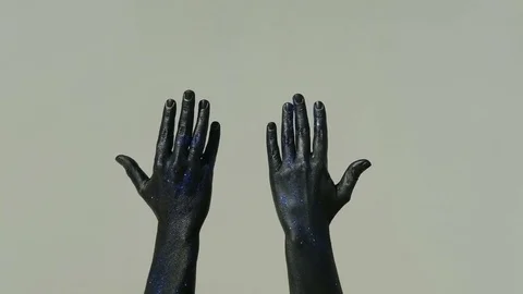 Black hands slide down the gray wall indoor Stock Footage 74833625