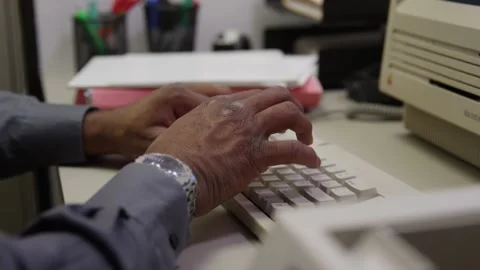 Black hands type on keyboard then tilt to old classic computer Stock Footage 131338666