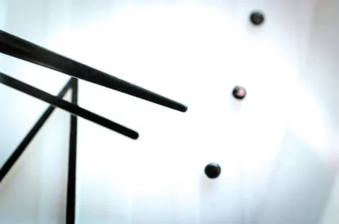 Black Hands on White Clock Face. Light Bulbs Reflections. Time Concept. Stock Photos