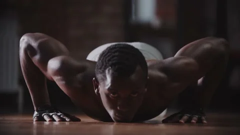 A black handsome athletic man training in the gym - doing push ups Stock Footage 146561793