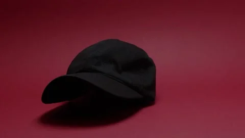 Black hat that falls on a red background Stock Footage 198371970