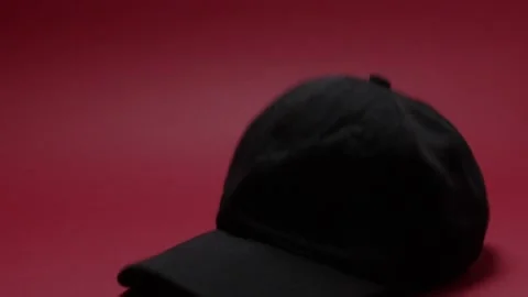 Black hat that falls on a red background Stock Footage 198371971