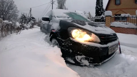 Black hatchback car stuck in big snowdrift. Winter transport problems. Stock Footage 102123339