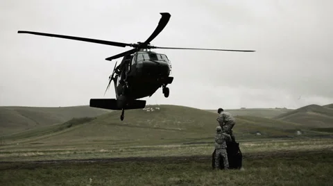 Black Hawk approaching cargo and soldiers attaching the hoist line. Stock Footage 52701864