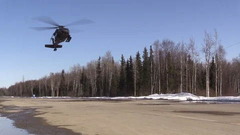 Black Hawk helicopter lands on a large open field Stock Footage 113296656