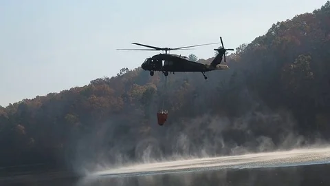 Black hawk helicopter picking up water Stock Footage 69842323
