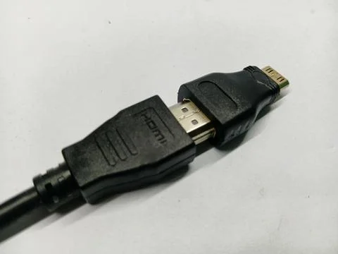 Black HDMI cable connected to a Micro HDMI adapter on white background Stock Photos