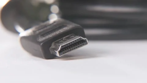 Black HDMI end of cable in slo mo white table surface 4k Stock Footage 329708324
