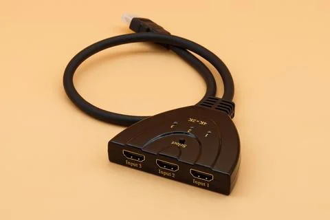 Black hdmi switcher with three input ports and one output cable. Stock Photos