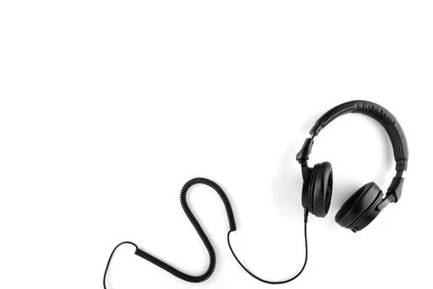 Black headphones with a wire on a white background. Stock Photos
