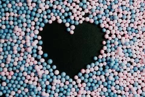 A black heart in the middle of pink and blue balloons love and equality con.. Stock Photos