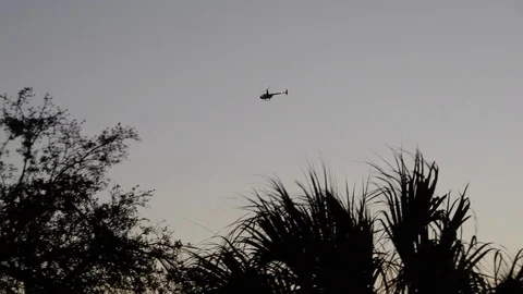 Black Helicopter Flying In Sky At Sunset Close To Dusk Tropical Location Stock Footage 126352053