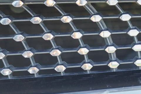 Black hexagonal grille with silver accents Stock Photos
