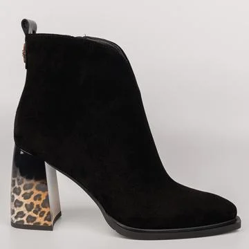 Black high-heel boot with leopard print detail and a smooth design placed a.. Stock Photos