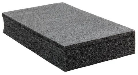 Black high-impact closed-cell polyethylene black foam brick isolated on white Photos