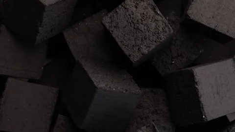 Black hookah charcoal cubes rotating in circle close up on dark background Stock Footage 311325953