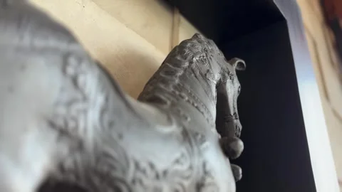 A black horse statue mounted on the wall. orbital camera movement and track in Stock Footage 322978530