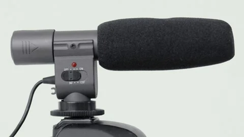 Black hot shoe microphone with wind noise reducer, rotates isolated on white Stock Footage 276375857