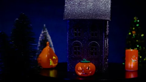 A black house surrounded by glowing pumpkins of various shapes rotates Stock Footage 319262943