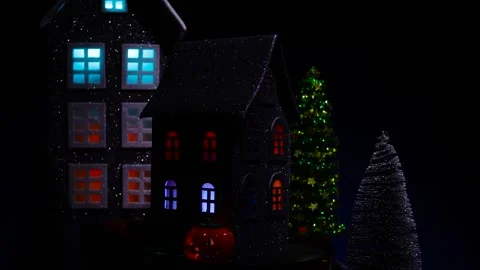 A black house surrounded by glowing pumpkins and candles rotates Stock Footage 319293660
