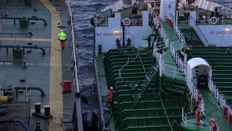 Black huge barrel floats between modern oil tankers Stock Footage 113195756
