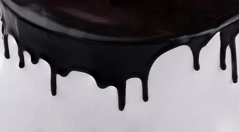 Black icing dripping down white cake minimalist dessert Stock Photos