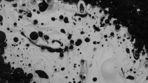 Black ink balls exploding on white background and then swept. Stock Footage 345829343