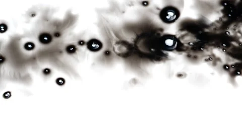 Black ink being dropped over white surface Stock-Footage 147702121
