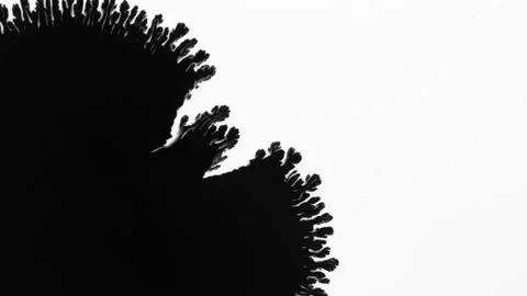 Black ink blot runs on white background. Stock Footage 154760153