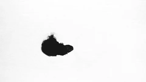 Black ink drops splatters spilling on white background Stock Footage 125463535