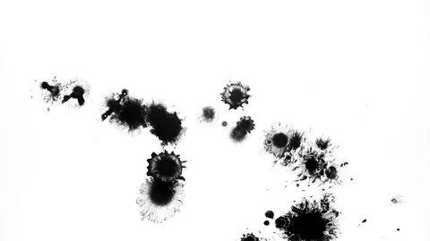 Black ink drops splatters spilling on white background Stock Footage 125469345