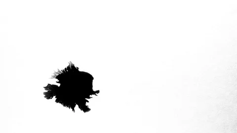 Black ink drops splatters spilling on white background Stock Footage 125470340