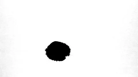 Black ink drops splatters spilling on white background Stock Footage 125471022