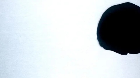 Black ink drops splatters spilling on white background Stock Footage 125472292