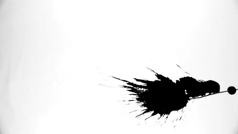 Black ink drops splatters spilling on white background Video stock 125472352