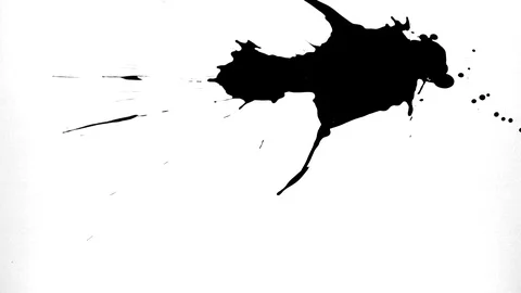 Black ink drops splatters spilling on white background Stock Footage 125472492