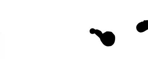 Black ink drops splatters spilling on white background Stock Footage 125472675