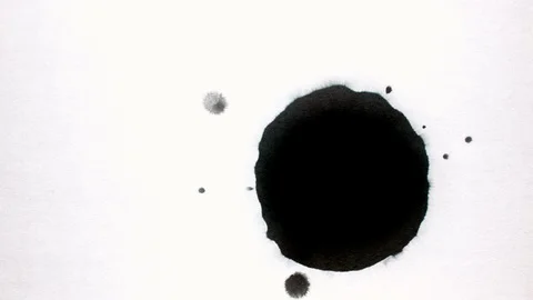 Black ink drops splatters spilling on white background Stock Footage 125472734