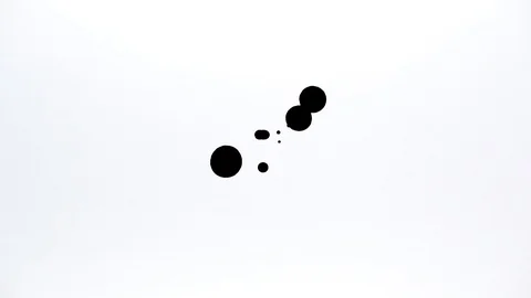 Black ink drops splatters spilling on white background Stock Footage 125473032
