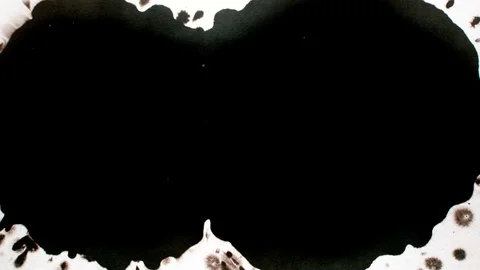 Black ink drops splatters spilling on white background Stock Footage 125473151