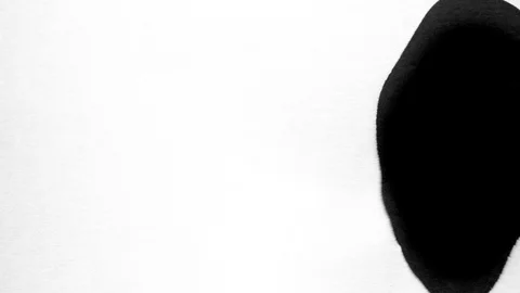Black ink drops splatters spilling on white background Video stock 125473453