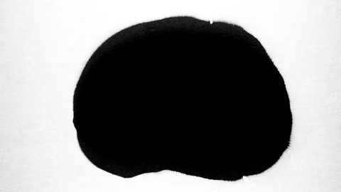 Black ink drops splatters spilling on white background Video stock 125475348