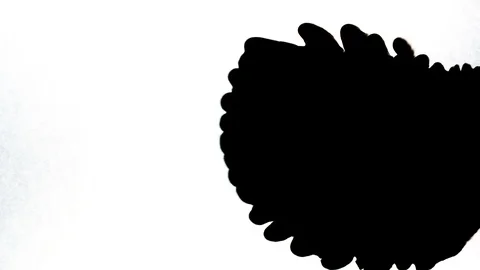 Black ink drops splatters spilling on white background Video stock 125476002