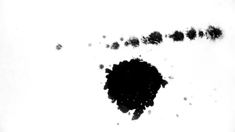 Black ink drops splatters spilling on white background Stock Footage 125476210