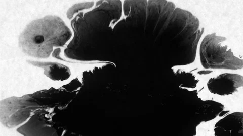 Black ink drops splatters spilling on white background Video stock 125476686